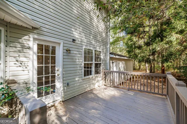 a view of a house with a large window and wooden fence