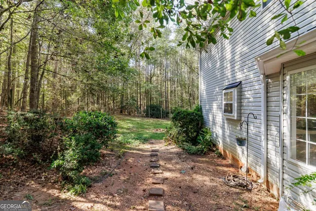 a view of a house with backyard and sitting area