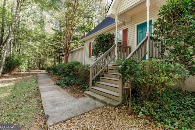 a view of a pathway of a house with wooden stairs