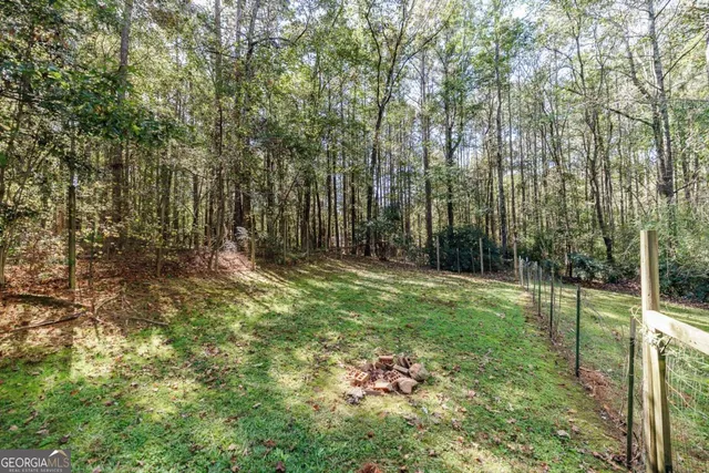 a view of outdoor space with green field and trees