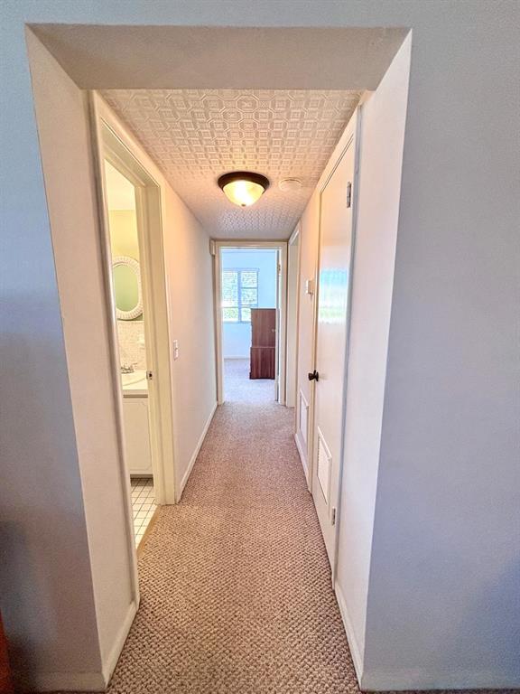 310 South Cypress Road, Unit 701 Pompano Beach, FL 33060 - Photo 11 of 34 - Hallway to bathroom and bedrooms