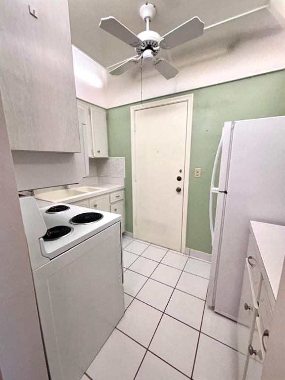 310 South Cypress Road, Unit 701 Pompano Beach, FL 33060 - Photo 8 of 34 - Kitchen with exit door