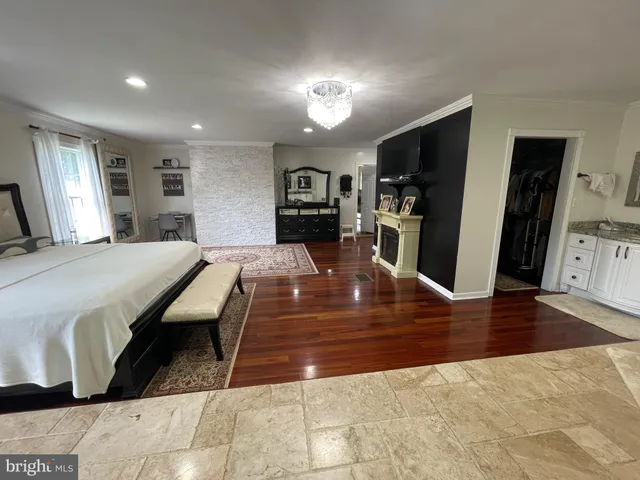 a kitchen with granite countertop stainless steel appliances a stove microwave and refrigerator