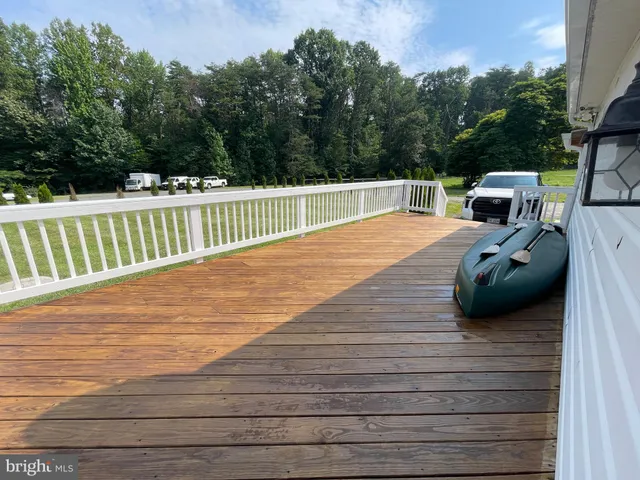 a bathroom with a toilet sink vanity and mirror