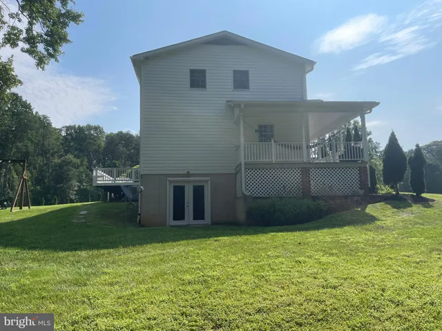 a view of a backyard with a garden and entertaining space