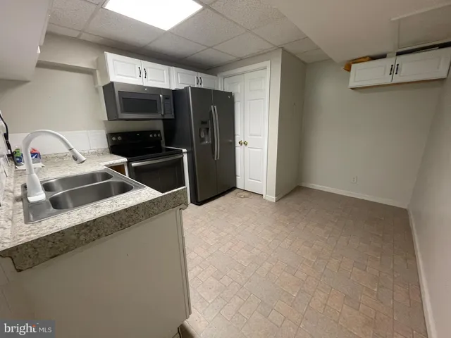 a view of a patio with table and chairs a barbeque with wooden floor and fence