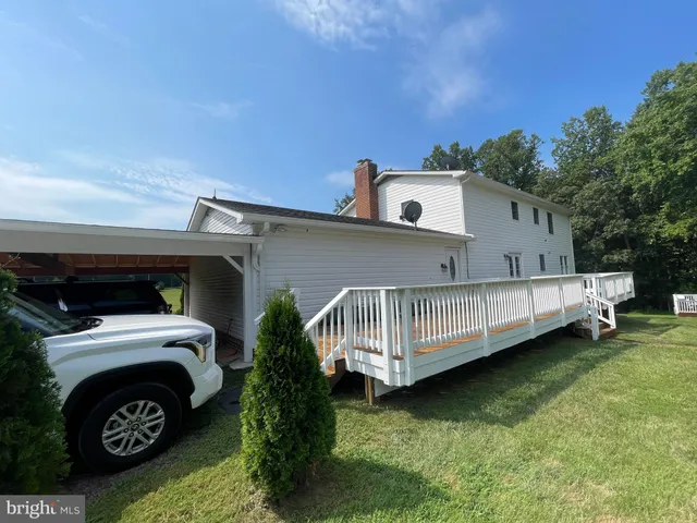 a view of a yard with a house in the background