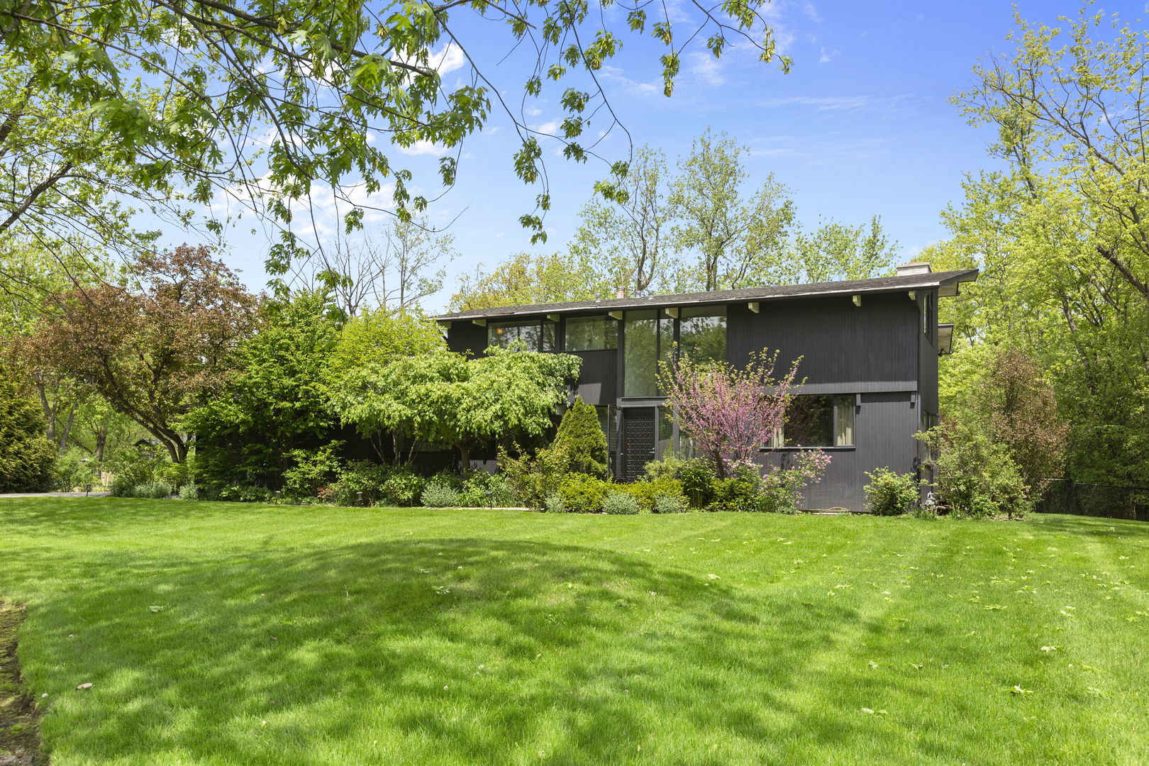 2440 West Course Drive Riverwoods, IL 60015 - Photo 1 of 19 a front view of a house with garden
