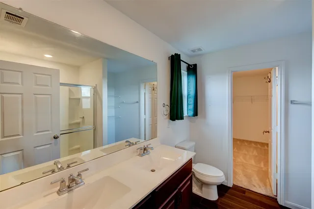 a bathroom with a sink a toilet and mirror