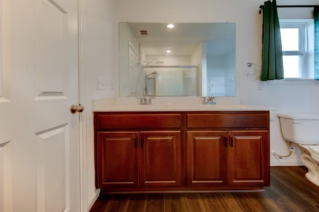 a bathroom with a sink a toilet and mirror