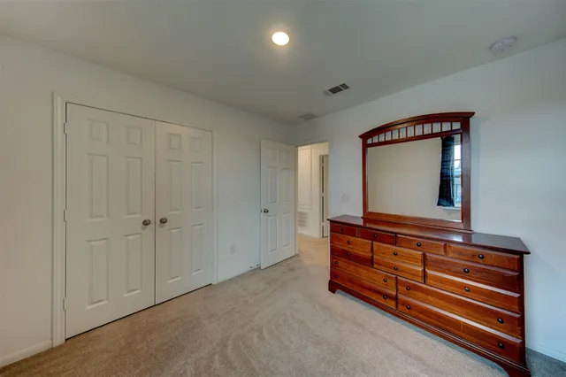 a view of room with wooden floor and cabinet
