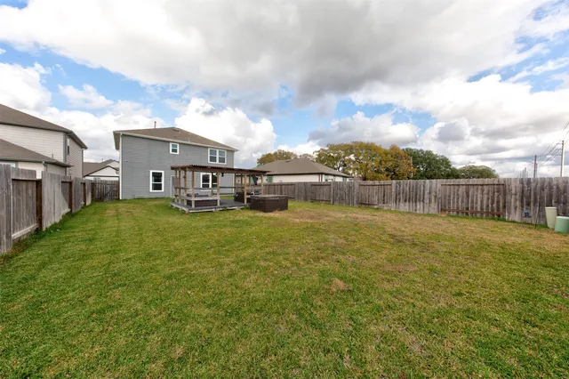 a view of a house with a yard and sitting area