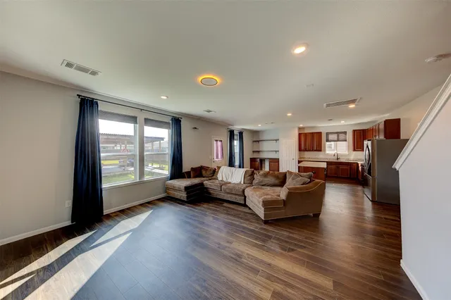 a living room with furniture and large windows