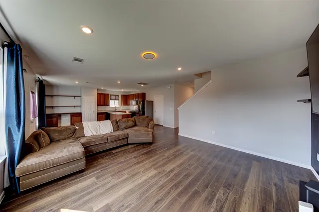 a living room with furniture and kitchen view