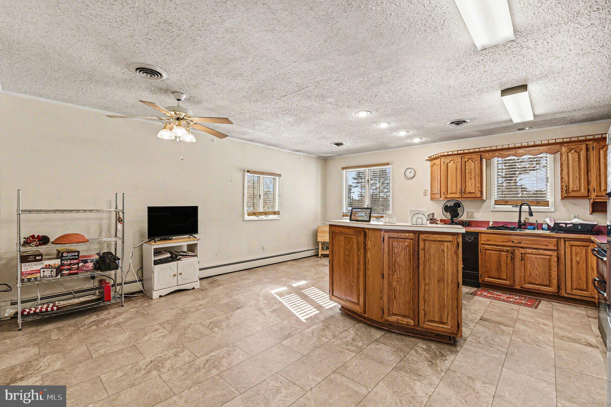 677 Dr Miller Road North East, MD 21901 - Photo 11 of 28 a living room with furniture a flat screen tv and a kitchen view