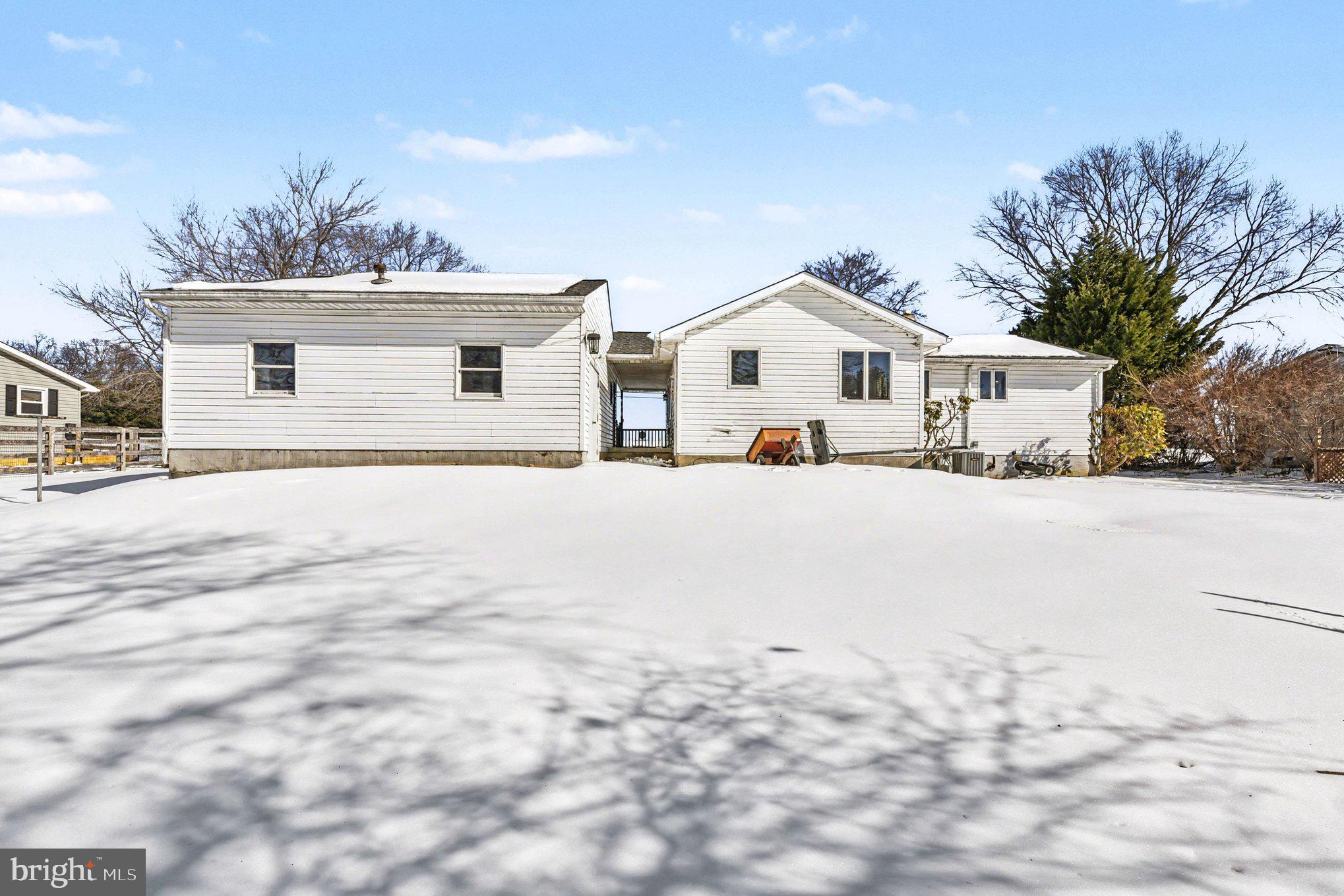 677 Dr Miller Road North East, MD 21901 - Photo 24 of 28 a view of a white house with a yard covered in snow