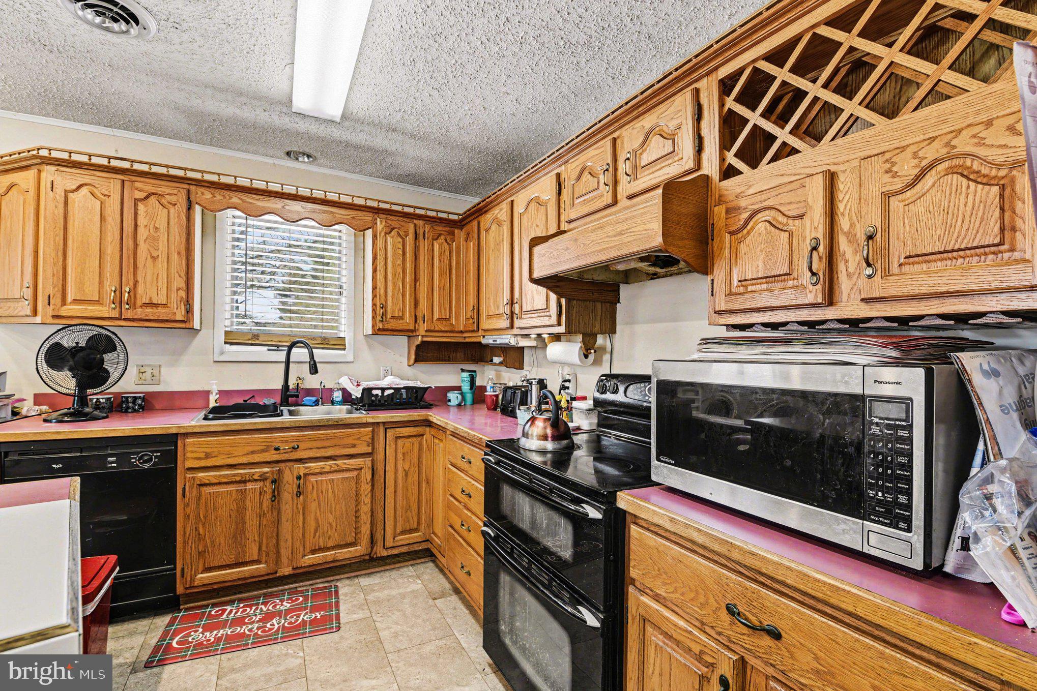 677 Dr Miller Road North East, MD 21901 - Photo 8 of 28 a kitchen with stainless steel appliances granite countertop a stove sink and cabinets