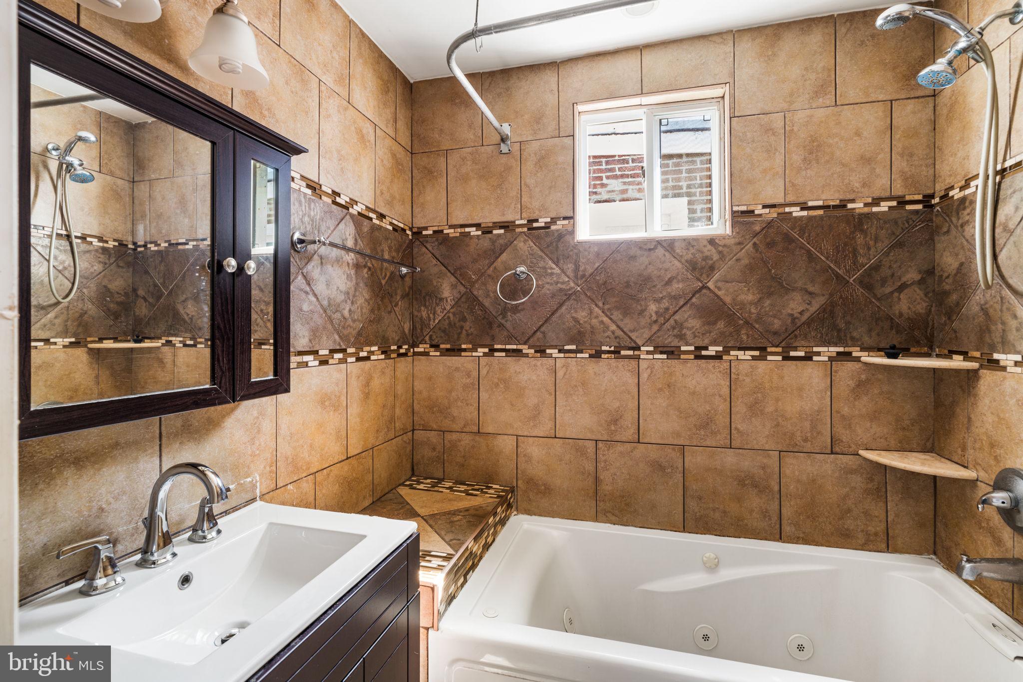 1824 Tasker Street Philadelphia, PA 19145 - Photo 20 of 26 a bathroom with a bathtub and shower
