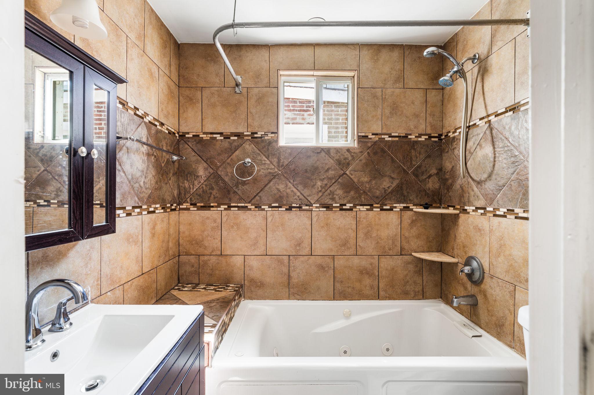1824 Tasker Street Philadelphia, PA 19145 - Photo 21 of 26 a bathroom with a sink and a shower