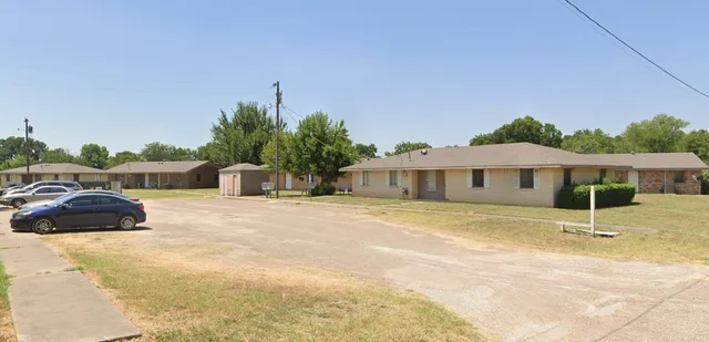 a view of a house with a yard and sitting area