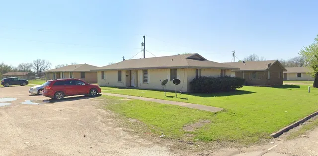 a view of a house with a yard and sitting area