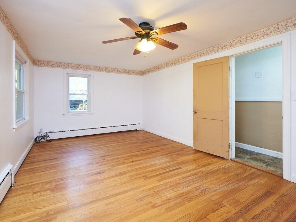 85 Shepard Road Sturbridge, MA 01566 - Photo 11 of 21 an empty room with wooden floor and ceiling fan
