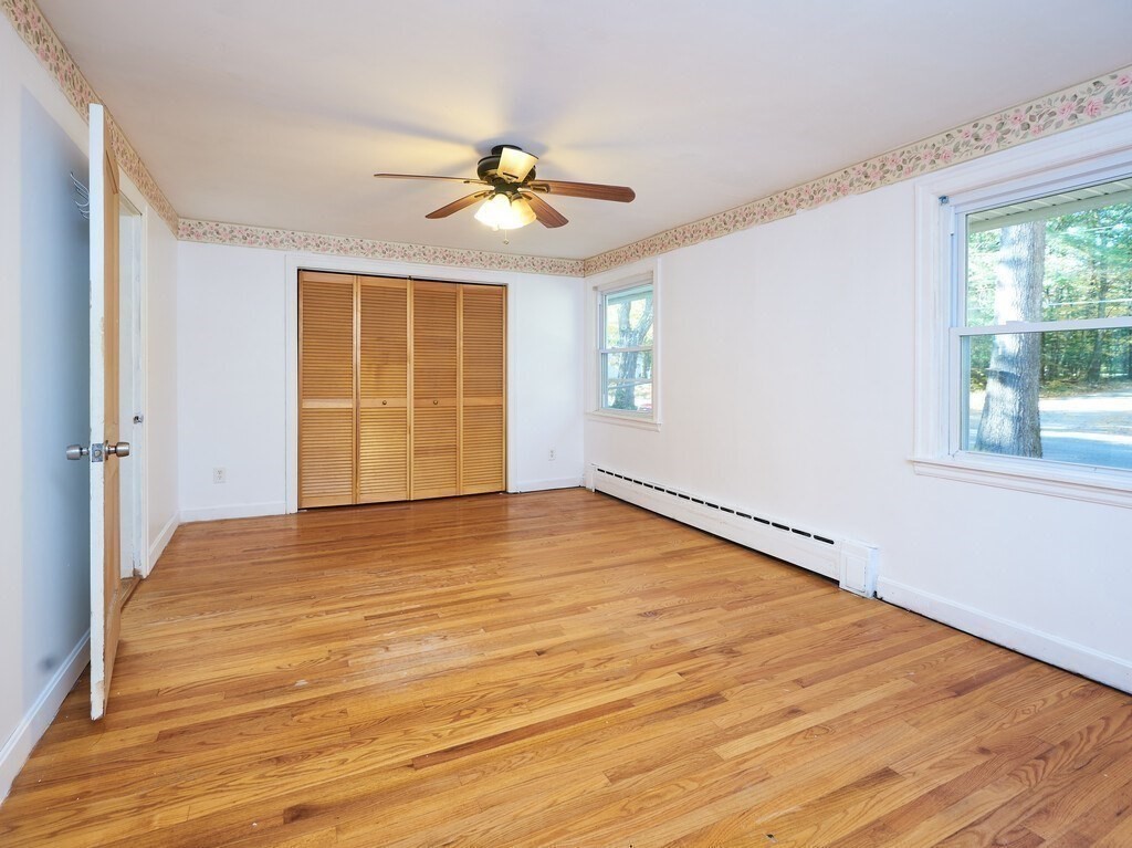 85 Shepard Road Sturbridge, MA 01566 - Photo 12 of 21 a view of an empty room with wooden floor and a window