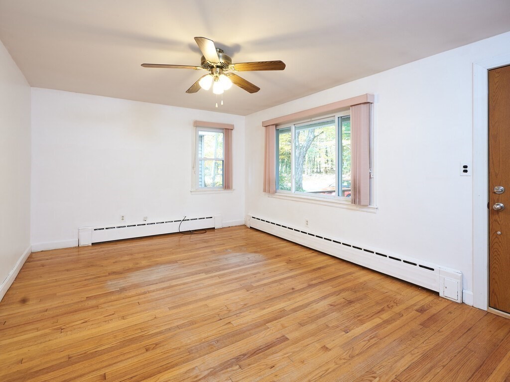 85 Shepard Road Sturbridge, MA 01566 - Photo 6 of 21 a view of an empty room with wooden floor and a window