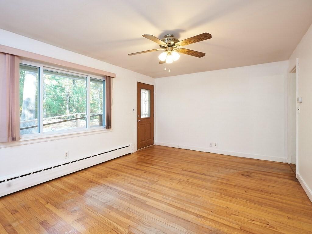85 Shepard Road Sturbridge, MA 01566 - Photo 7 of 21 a view of an empty room with wooden floor and a window
