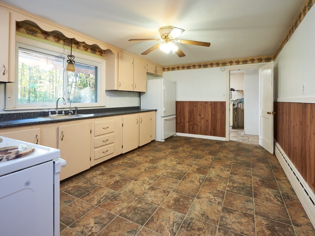85 Shepard Road Sturbridge, MA 01566 - Photo 8 of 21 a large kitchen with granite countertop a stove a sink and a refrigerator