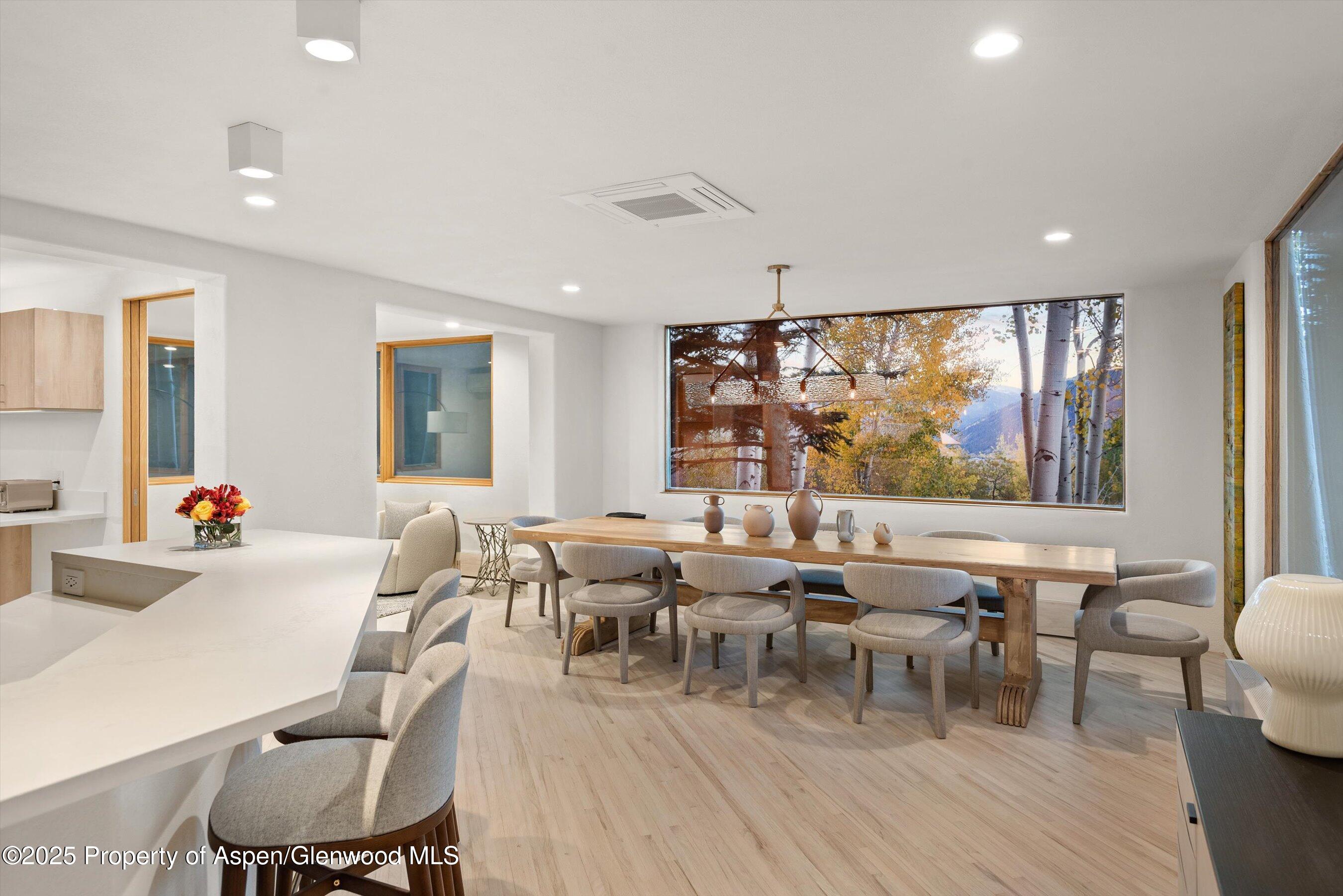 699 Eppley Drive Aspen, CO 81612 - Photo 11 of 45 a room with lots of tables a large window and chairs