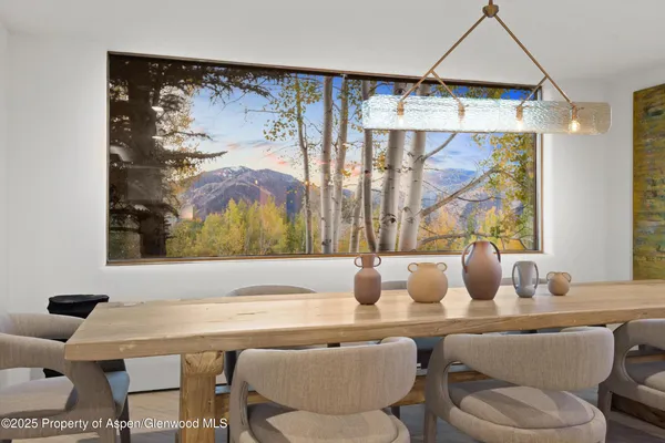 a dining room with furniture and window