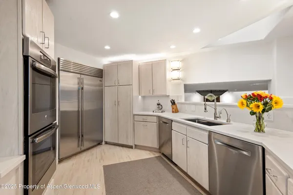 a kitchen with a sink and refrigerator