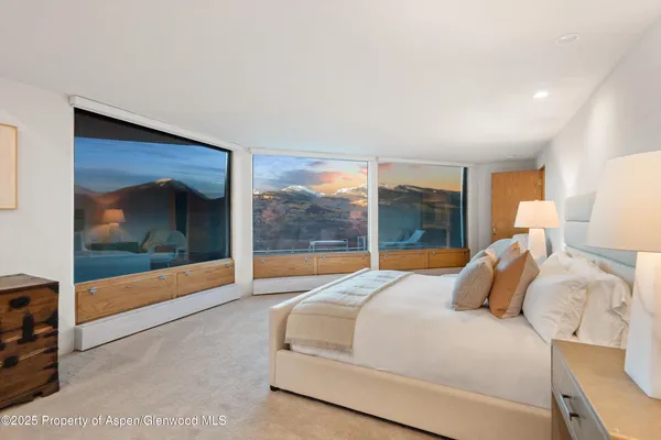 a bedroom with a large bed and a large window