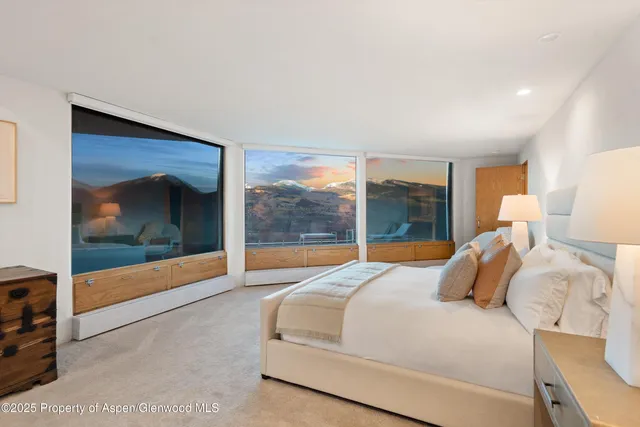 a bedroom with a large bed and a large window