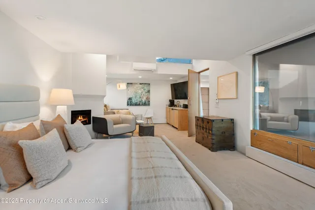 a large bedroom with a large bed and flat tv