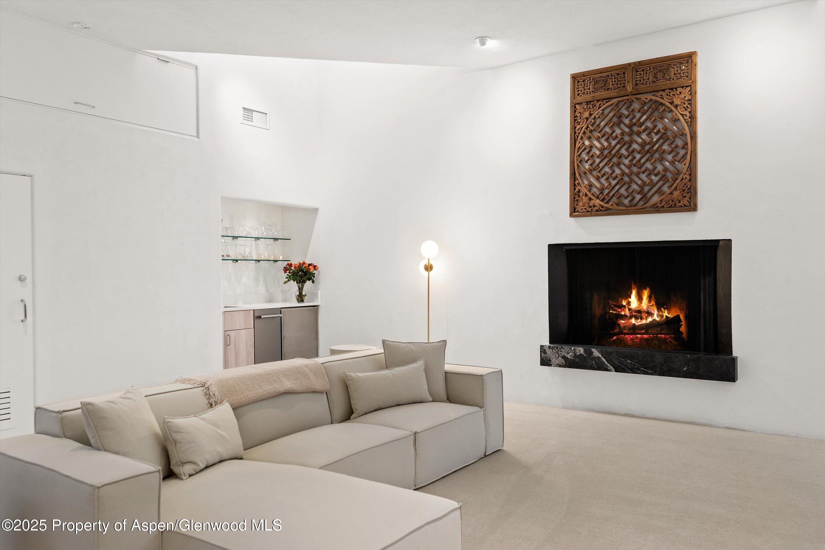 699 Eppley Drive Aspen, CO 81612 - Photo 22 of 45 a living room with furniture a fireplace and a flat screen tv