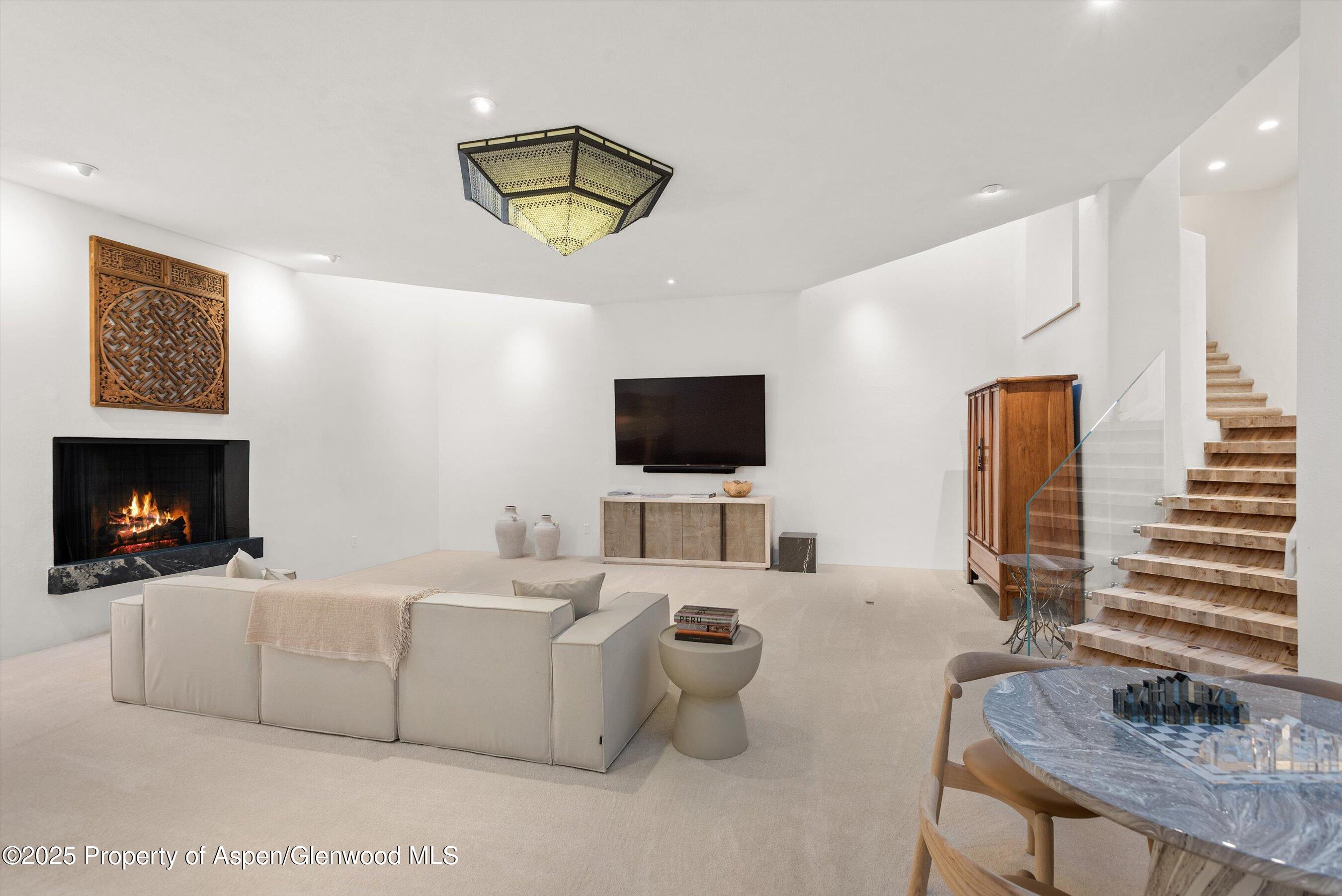 699 Eppley Drive Aspen, CO 81612 - Photo 23 of 45 a living room with furniture and a flat screen tv