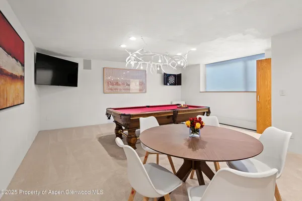a dining room with a table and chairs