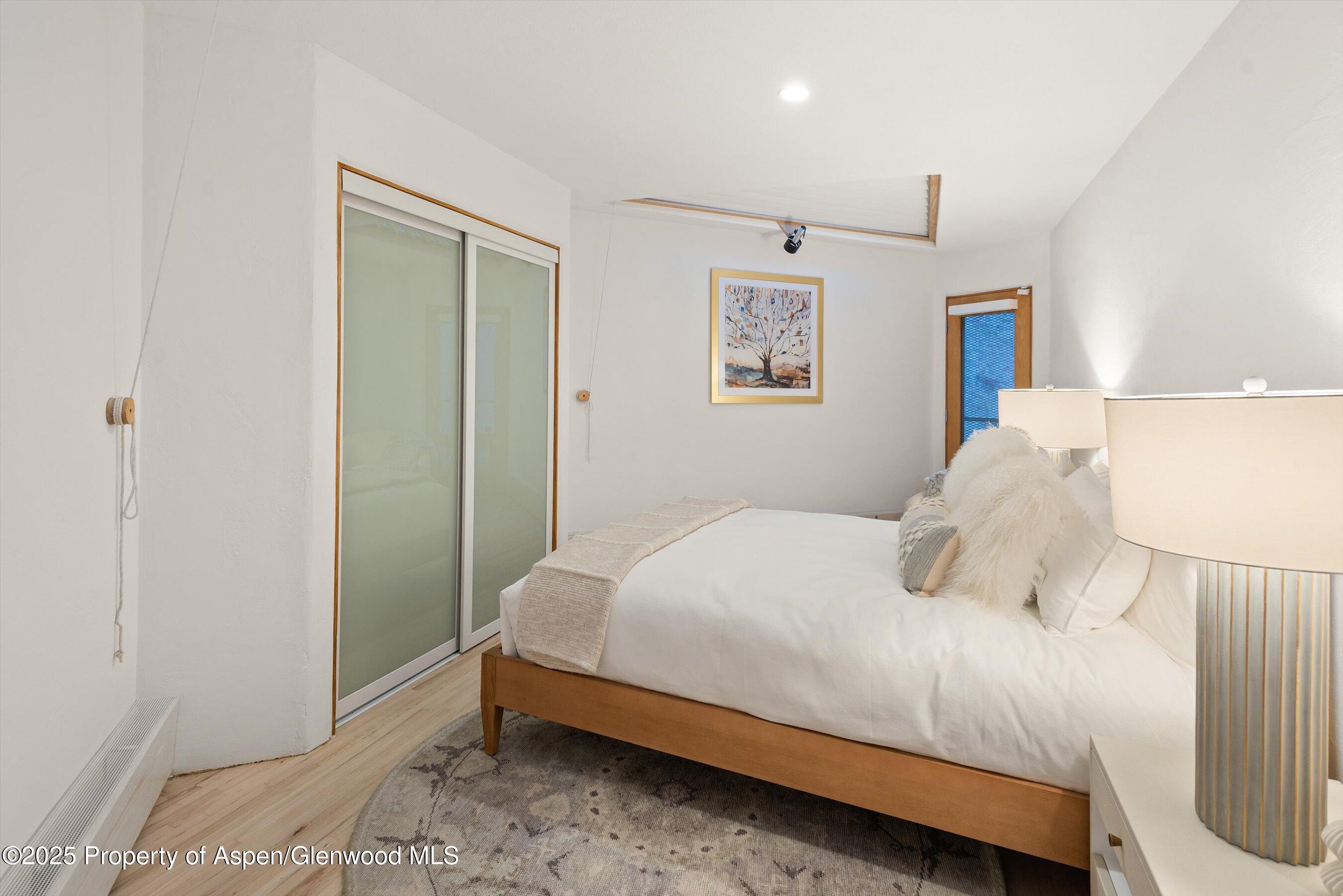 699 Eppley Drive Aspen, CO 81612 - Photo 29 of 45 a bedroom with a bed and a window