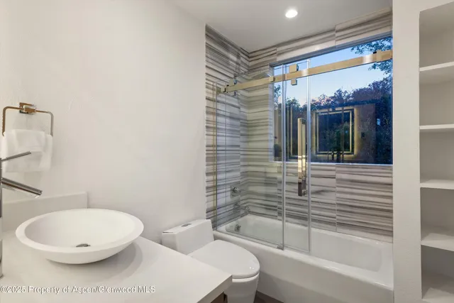 a bathroom with a toilet a sink and bathtub