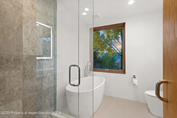 a bathroom with a toilet sink and tub