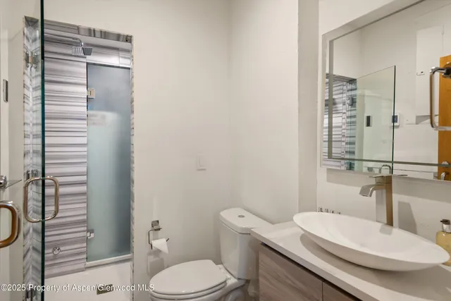 a white toilet sitting next to a bathroom sink
