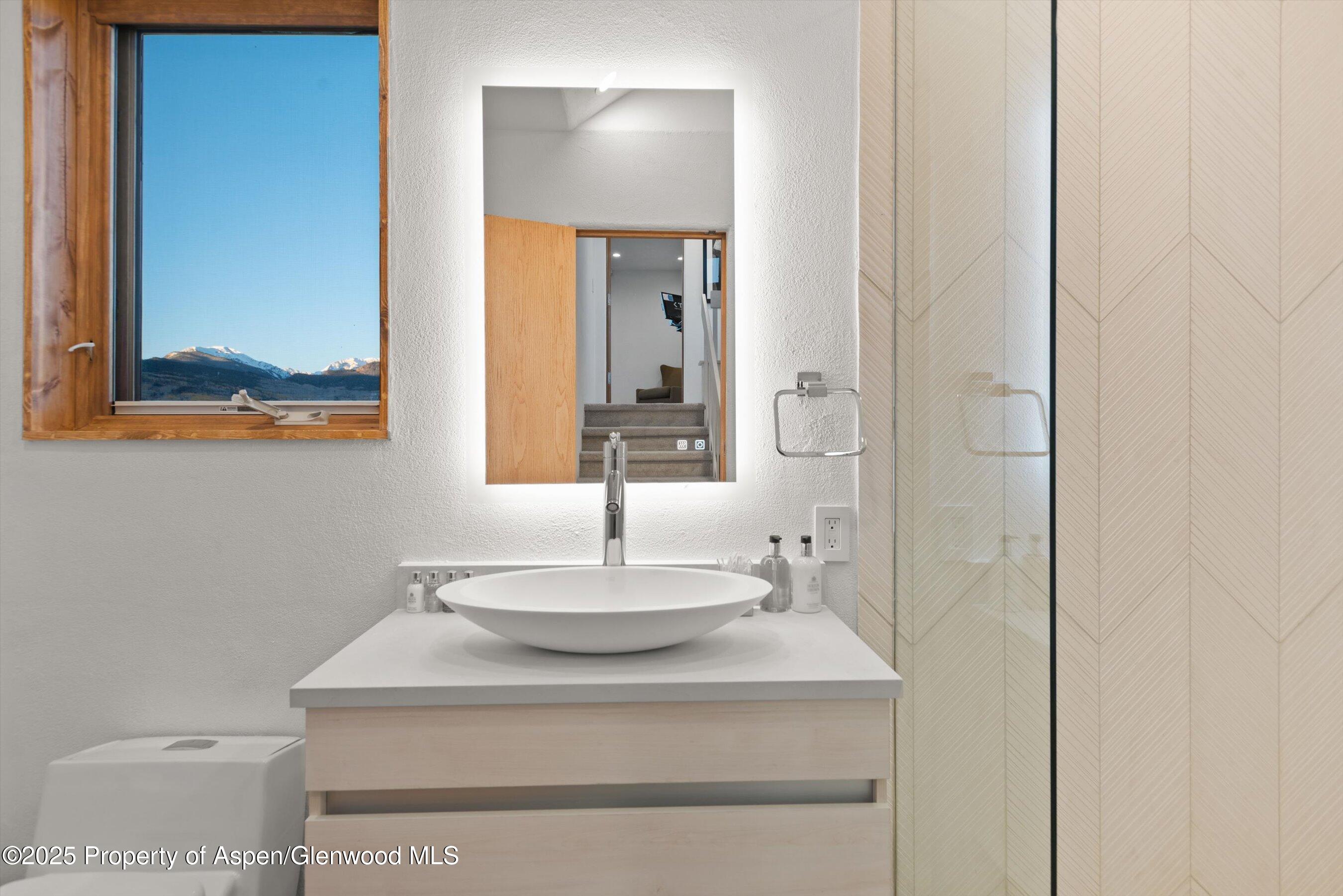 699 Eppley Drive Aspen, CO 81612 - Photo 36 of 45 a bathroom with a sink and a mirror