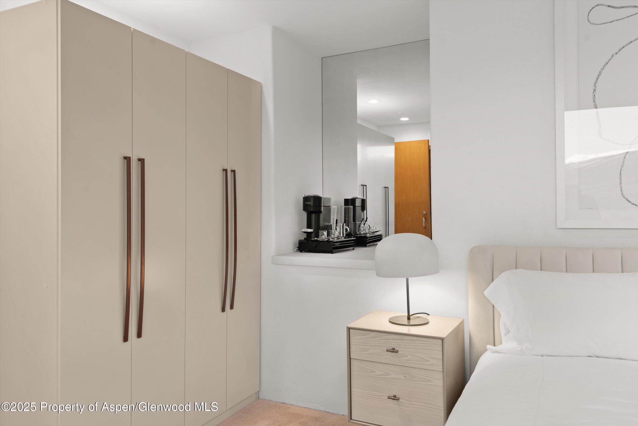 699 Eppley Drive Aspen, CO 81612 - Photo 37 of 45 a room with a sink a lamp and a mirror