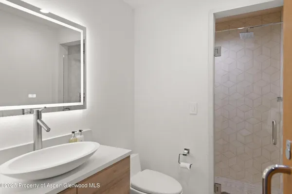 a bathroom with a sink toilet and mirror