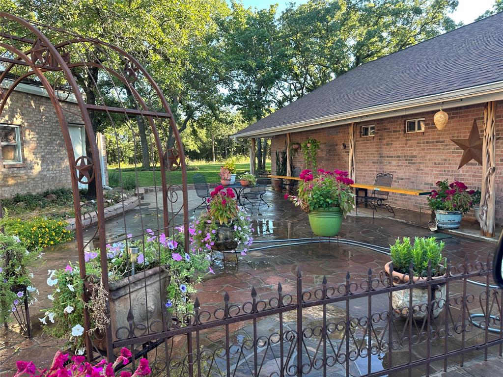 1149 Country Club Road Bowie, TX 76230 - Photo 1 of 17 a view of a backyard with garden