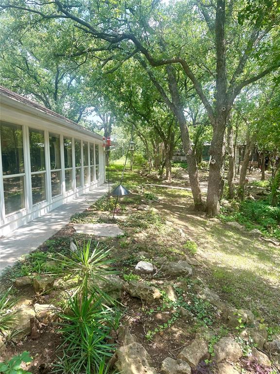 1149 Country Club Road Bowie, TX 76230 - Photo 12 of 17 a view of a house with a yard