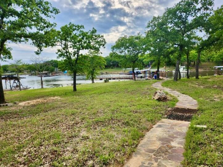 1149 Country Club Road Bowie, TX 76230 - Photo 3 of 17 a view of a backyard with large trees