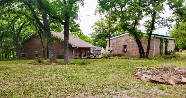 1149 Country Club Road Bowie, TX 76230 - Photo 4 of 17 a front view of house with yard and green space